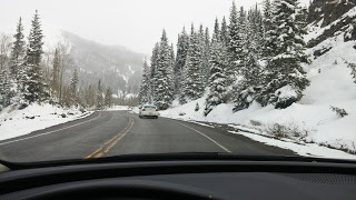 driving on the snow-capped Million Dollar Highway in May from Telluride to Durango Colorado