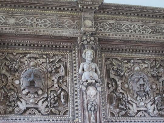 The wood-carved fireplace.