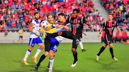 Ottawa's Julian de Guzman (25) challenges Edmonton's Daryl Fordyce for the ball. PHOTO: OTTAWA FURY