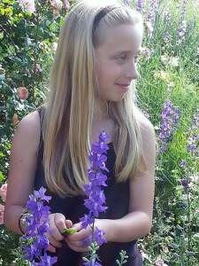 Emma in the garden with larkspur1