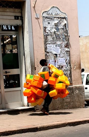 A boy collects empty canisters to sell on the streets of Asmara.