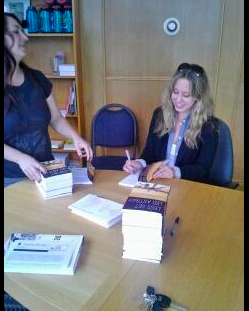 Signing books at Powell's, thinking I was hot shit