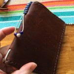 The loop with the beads can be tightened to hold refills inside the notebook.