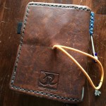 I used an awl to poke a hole in the back cover to attach this elastic. This is the same style that Midori uses, which puts a knot in the back that some people don't like. It doesn't bother me, though.