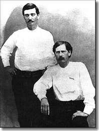 Wyatt Earp and Bat Masterson. Wyatt is seated.