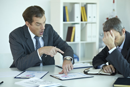 Male boss yelling at his office worker