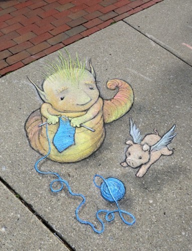 Knitting on the sidewalk with a flying pig as one does...