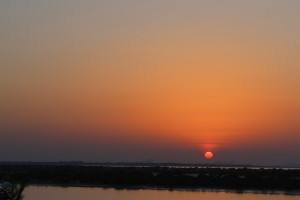 The sun sets over the Arabian desert near Abu Dhabi, UAE. 