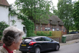 Jane Hurst discussing the thatched cottage in the background