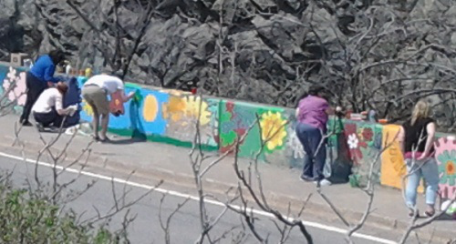 Volunteers painting a concrete barricade wall in Saint John, NB, May 2015