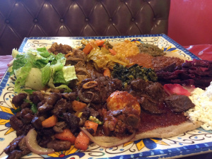 This is a meal served in an Ethiopian restaurant. Usually, the meal is shared. Your POV character is someone who does not like to share food (they didn't choose this restaurant). But, they are also meeting someone they consider important. How does your POV character act in this situation?
