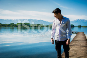 stock-photo-65016913-attractive-young-man-on-lake-in-sunny-peaceful-day