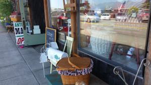 A festive July 4th scene outside the antique store which in the story is owned by Ivy and where the heroine and seventeen year old Maddie pick out vintage items for the cottage. 