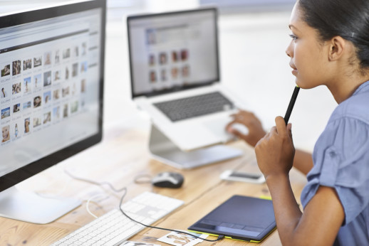 A young editor deciding on images to use in her publication
