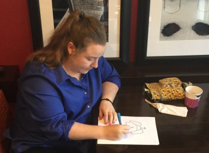 Cassie Beasley eating breakfast and drawing an elephant's butt