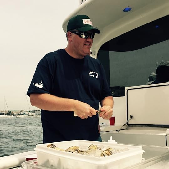 Chris Himmel demonstrates the proper way to shuck an oyster. (Photo by Scott Bridges)