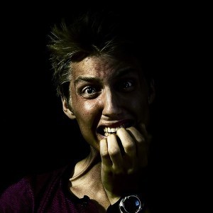 Picture of nervous woman biting nails.