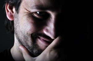 young man smiling in the dark