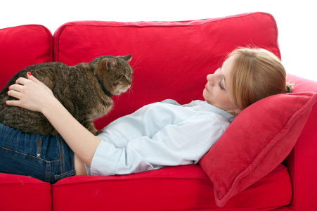 lying on red sofa young woman with cat