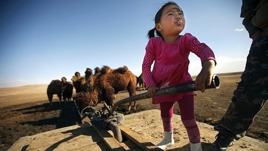 Amin-Erdene Galkhuu pumps well water to her family's Bactrian camels in Mongolia's South Gobi region. 
