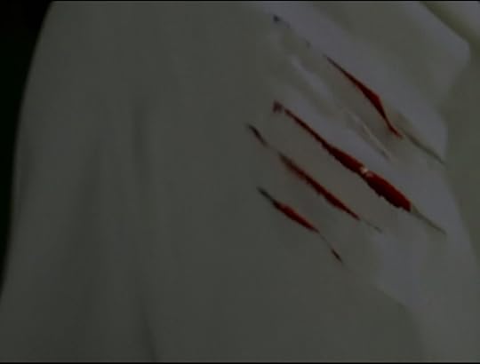 Dr. Backer's lab coat, with bloody claw marks through it.