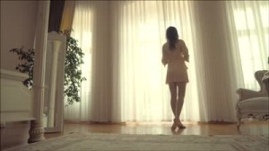 Woman in white lingerie standing by window - HD stock video clip