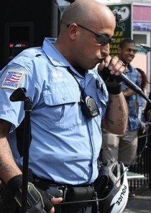 A policeman croons into a microphone.