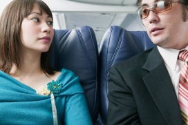 Adult couple traveling in an airplane