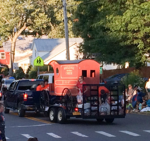 Should every parade have an antique cheese cart? And yes, they're throwing cheese off the back.
