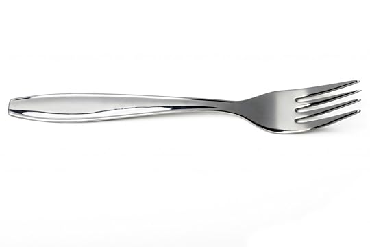 Close up view of a kitchen table fork isolated on a white background.