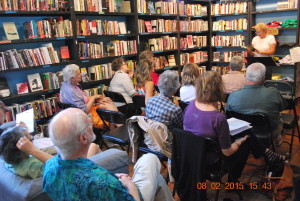Annette Oppenlander reading in front of a group in a bookstore