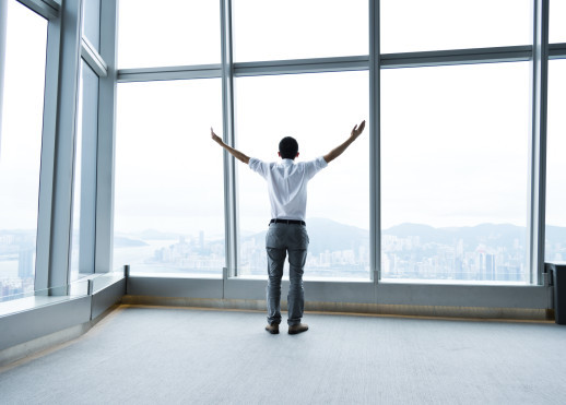 Businessman with the arms up expressing freedom.