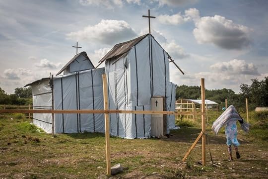A woman enters the site of a church in a make shift camp near the port of Calais on July 31, 2015 in Calais, France. Strike action and daily attempts by hundreds of migrants to enter the Channel Tunnel and onto trains heading to the United Kingdom is causing delays to passenger and freight services across the channel. British Prime Minster David Cameron has announced that extra sniffer dogs and fencing are to be sent to Calais and land owned by the Ministry of Defence is to be used as a lorry park to ease congestion near the port of Dover in Kent.