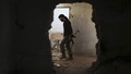 A fighter from the Free Syrian Army's Al Rahman legion carries his weapon as he moves inside a damaged building on the frontline against the forces of Syria's President Bashar al-Assad in Jobar, a suburb of Damascus, Syria July 27, 2015.