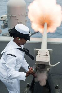 Woman sailor fires ship artillery