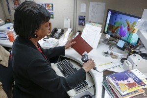 Deborah Vaden completes the call number and scans the barcode.
