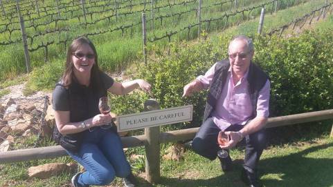 rob and ruth pointing at sign