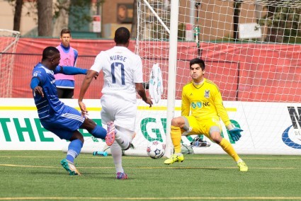 Carolina keeper Akira Fitzgerald makes a save on FCE winger Lance Laing. PHOTO: TONY LEWIS/FC EDMONTON