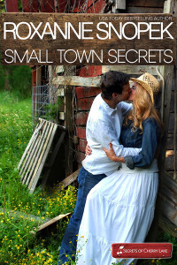 A couple embracing against an old, tumble-down barn