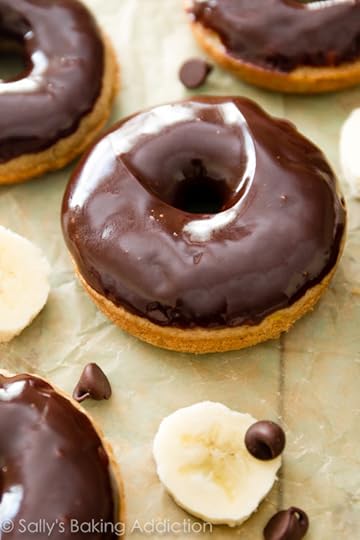 Baked banana donuts covered in a silky smooth dark chocolate glaze-- so decadent, yet totally simple to make!