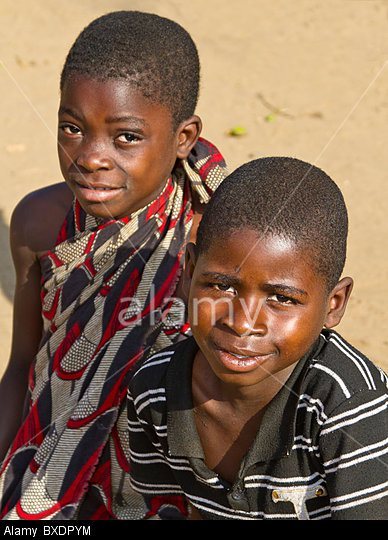 A oung boy and girl smile shyly in their village, Kawaza, in Zambia, Africa. 