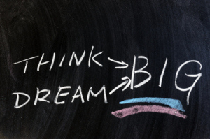 Think and dream big words written on chalkboard