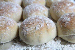 A tray of freshly baked Scottish morning rolls or baps, close-up