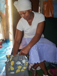 Masiiwe looking at the contents of the bags from The Pear Tree Project