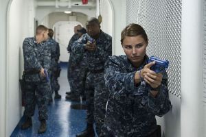 150812-N-UY393-367 SAN DIEGO (Aug. 12, 2015) Seaman Blythe Wallace, assigned to the amphibious assault ship USS America (LHA 6), executes a security simulation during Between the Lifelines (BTL) training aboard the barge. BTL is a two-week security training program that provides the fundamentals of watch standing and non-lethal weapons to Sailors. America is undergoing a post-shakedown availability (PSA) in which the ship's crew and assigned contractors make improvements to the ship's design. America's PSA will pave the way for future America-class amphibious assault ships. (U.S. Navy photo by Mass Communication Specialist 3rd Class William Berksteiner/Released)