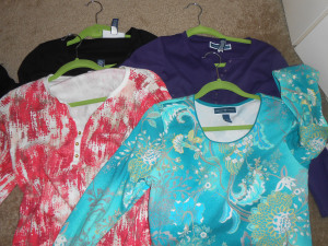 Four long sleeved shirts: Purple and black in back, pinkish orange and blue in front