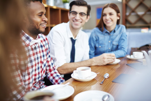 Multi-ethnic group of young people talking over a cup of coffee