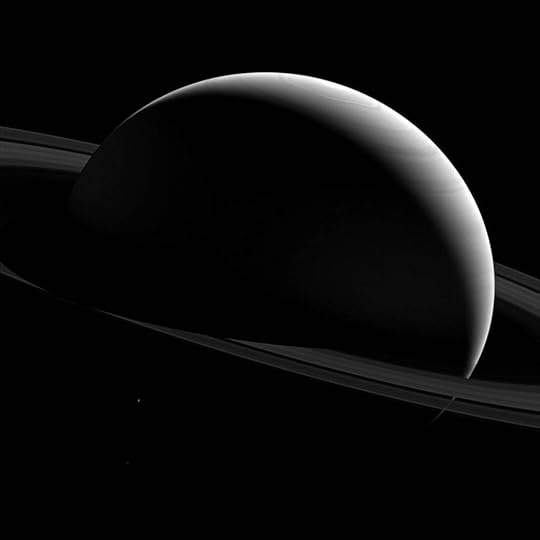 NASA picture of Saturn and the moon Tethys, taken by the Cassini probe