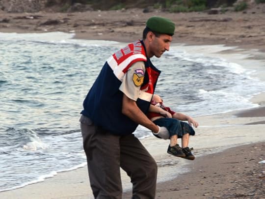 ADDS IDENTIFICATION OF CHILD A paramilitary police officer carries the lifeless body of Aylan Kurdi, 3, after a number of migrants died and a smaller number were reported missing after boats carrying them to the Greek island of Kos capsized, near the Turkish resort of Bodrum early Wednesday, Sept. 2, 2015. The family ó Abdullah, his wife Rehan and their two boys, 3-year-old Aylan and 5-year-old Galip ó embarked on the perilous boat journey only after their bid to move to Canada was rejected. The tides also washed up the bodies of Rehan and Galip on Turkey's Bodrum peninsula Wednesday, Abdullah survived the tragedy. (AP Photo/DHA) TURKEY OUT