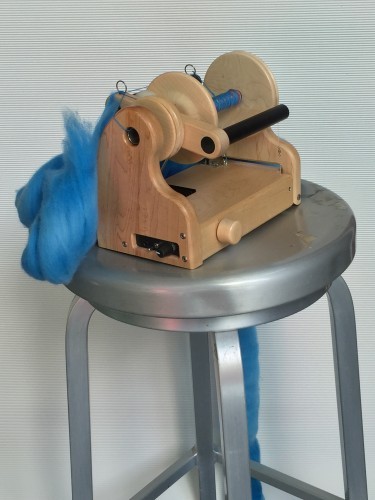 Bar stool spinning! The pretty blue fiber is cjkohoDesigns merino in the Castiel colorway.